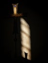 Vertical shot of a cross with a shadow cast over it Royalty Free Stock Photo