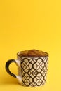 Vertical shot of a cup of hot chocolate isolated on a yellow background Royalty Free Stock Photo
