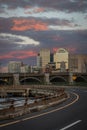 Vertical shot of a curvy road against the city buildings and sky at sunset. Boston, Massachusetts. Royalty Free Stock Photo