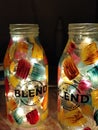 Vertical shot of custom blend glass bottles painted with color and decorated with fairy lights