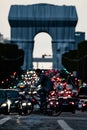 Vertical shot of the cyclist in front of the Triumphal Arch during the traffic