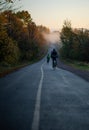 Vertical shot of cyclists riding on a countryside road on a morning Royalty Free Stock Photo