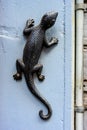 Vertical shot of decorative metallic lizard on the wall Royalty Free Stock Photo