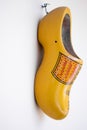 Vertical shot of a decorative yellow clog shoe