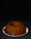 Vertical shot of a delicious chocolate cake baked in a bundt pan and covered in ganache Royalty Free Stock Photo