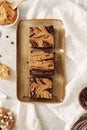 Vertical shot of delicious peanut butter swirl brownies on top on a white table
