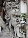 Vertical shot of a demon guardian carved out of stone in a temple in bangkok thailand