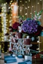 Vertical shot of a dessert corner of a restaurant with sweets and flower put on a mirror table