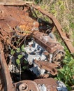 Vertical shot of the details of a rusty old iron mechanism in the field