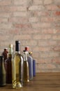 Vertical shot of different types of bottles of alcoholic drinks.Wine, whiskey, vodka and other drinks on the bar counter against o Royalty Free Stock Photo