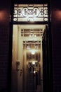 Vertical shot of a dimly lit doorway entrance of an apartment building