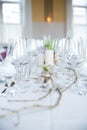 Vertical shot of a dining table with wine glasses and plates Royalty Free Stock Photo