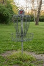 Vertical shot of a disk golf basket found in a park on a sunny day Royalty Free Stock Photo