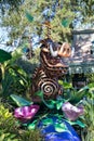 Vertical shot of a Disney cartoon character Pumbaa sculpturein a garden in Disneyland, France