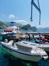 Vertical shot of a docked boat at the pier during daytime in Petrovac, Montenegro