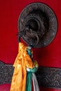 Vertical shot of a door handle with colorful prayer flags and cloth in a Buddhist monastery in Nepal Royalty Free Stock Photo