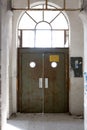 Vertical shot of a door of old abandoned industrial building, Pordenone, Italy