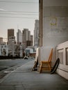 Vertical shot of dramatic scene with a chair on the sidewalk of Los Angeles streets, CA, USA