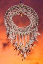 Vertical shot of a dreamcatcher under the sky during a sunset