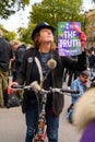 Vertical shot of eccentric Extinction Rebellion Protester holding a protest sign Royalty Free Stock Photo