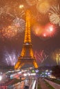 Vertical shot of the Eiffel Tower on amazing fireworks background