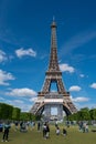 Vertical shot of The Eiffel Tower with tourists, seen from Champ de Mars on a sunny in Paris