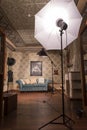 Vertical shot of an empty vintage style photo studio interior with lightning pieces of equipment