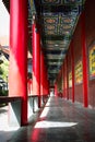 Vertical shot of an entrance of a Buddhist temple with red columns
