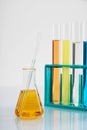 Vertical shot of Erlenmeyer flask with yellow liquid and a large dropper next to test tubes at a lab Royalty Free Stock Photo