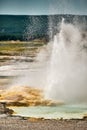 Vertical shot of an erupting geyser in Yellowstone National Park, Wyoming USA Royalty Free Stock Photo