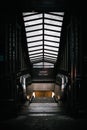 Vertical shot of the escalator of a subway station underpass with the exit sign Royalty Free Stock Photo