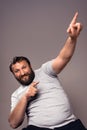 Vertical shot of an excited Caucasian man with his fingers up