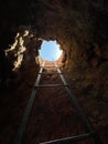 Vertical shot of the exit to the surface from the cave, Armenia Royalty Free Stock Photo