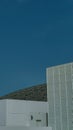 Vertical shot of the exterior of the Louvre in Abu Dhabi