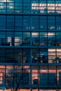 Vertical shot of the exterior of a modern glass building in Munich, Bavaria, Germany Royalty Free Stock Photo