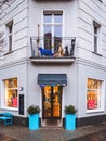 Vertical shot of the facade of a beautiful toyshop with toys behind the windows and on the balcony