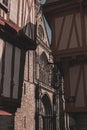 Vertical shot of the facade of Cathedral of the city of Vannes, France, seen through buildings
