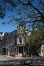 Vertical shot facade of classic building and a street with trees on a sunny day in San Jose in Costa Rica