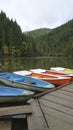 Vertical shot of the famous Red Lake with colorful boats near the dock in Lack Rosu, Romania