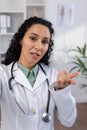 Vertical shot, female doctor seriously talking and consulting patient looking remotely into phone camera, using Royalty Free Stock Photo