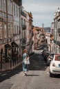 Vertical shot of a female walking down the beautiful streets of Lisbon