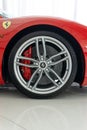 Vertical shot of a Ferrari 488 GTB Rosso Corsa with a silver wheel with carbon hub cap Royalty Free Stock Photo