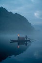 Vertical shot of a fisherman on a picturesque misty lake in Chenzhou,China Royalty Free Stock Photo