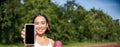 Vertical shot of fit and healthy young asian woman, shows smartphone screen with her workout stats, recommends telephone