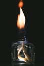 Vertical shot of the flames of a scent diffuser in the dark Royalty Free Stock Photo