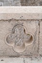 Vertical shot of a floral shape on a stone wall in Dubrovnik, Croatia