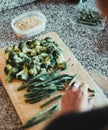 Vertical shot fo a human cutting broccolis and asparaguses Royalty Free Stock Photo