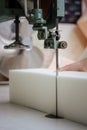 Vertical shot of a foam cutter machine, cutting through an upholstery foam