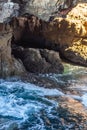 Vertical shot of foamy sea waves crashing against rocks in Cascais, Portugal Royalty Free Stock Photo