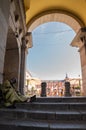 Vertical shot of a foreigner sleeping on the stairs of the Plaza Mayor in Madrid Royalty Free Stock Photo